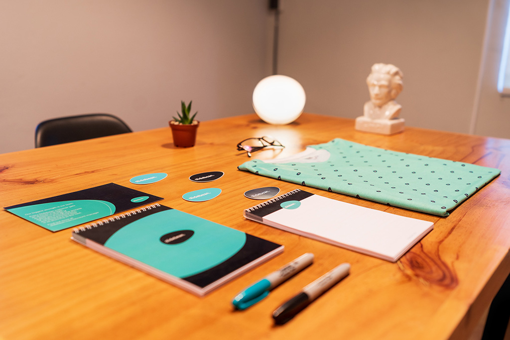 Notebooks and pens aligned on a table with similar design, look and feel