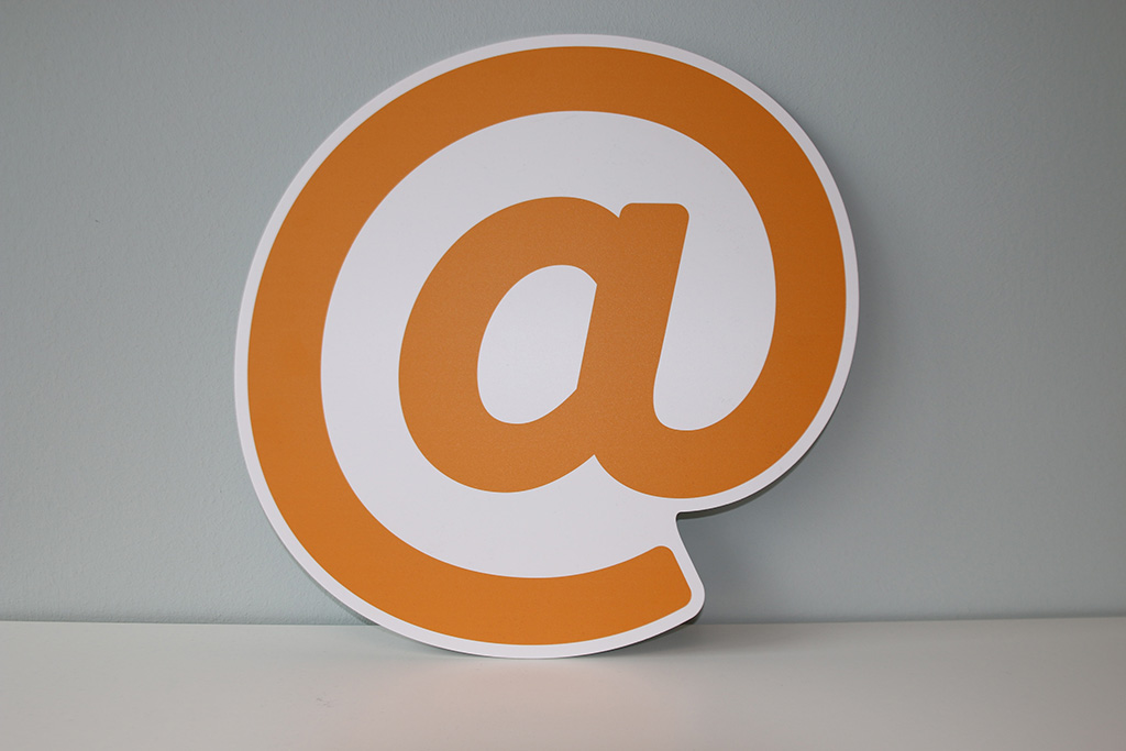 alt="A huge "at sign" in pastel orange color and white stroke | Email marketing strategies from Shizzle Marketing's experts"